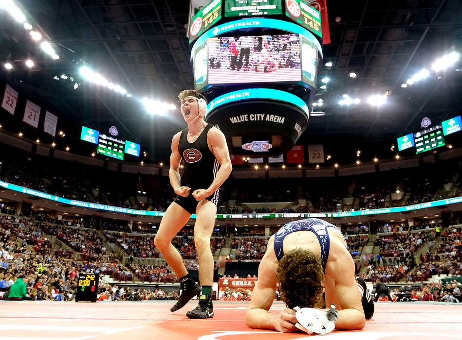 Sports Feature - HMGenoa's Dustin Morgillo (left) celebrates after defeating Ashtabula St. John's Nick Burgard at 145 pounds during the Division III  state individual wrestling championship finals at Schottenstein Center in Columbus.(Kurt Steiss / The Blade )